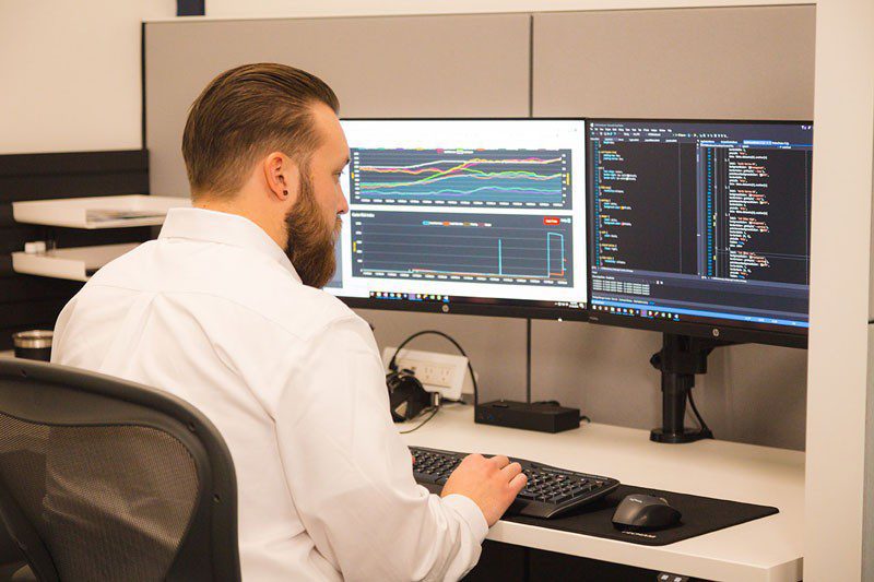 Man working on double monitors with advances AccuTEST software