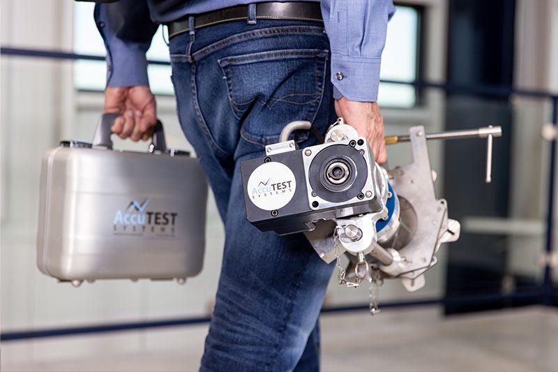AccuTEST service technician carrying equipment